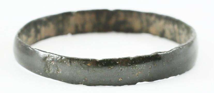 VIKING WOMAN’S WEDDING RING, 866-1067 AD SIZE 7 ¾: Bronze, originally gilt, size 7 3/4. 2.9mm, width with low rounded face. One small crisp mark to the surface, probably a clan mark. Cast with a central core to distribute the heat and molten metal. Th
