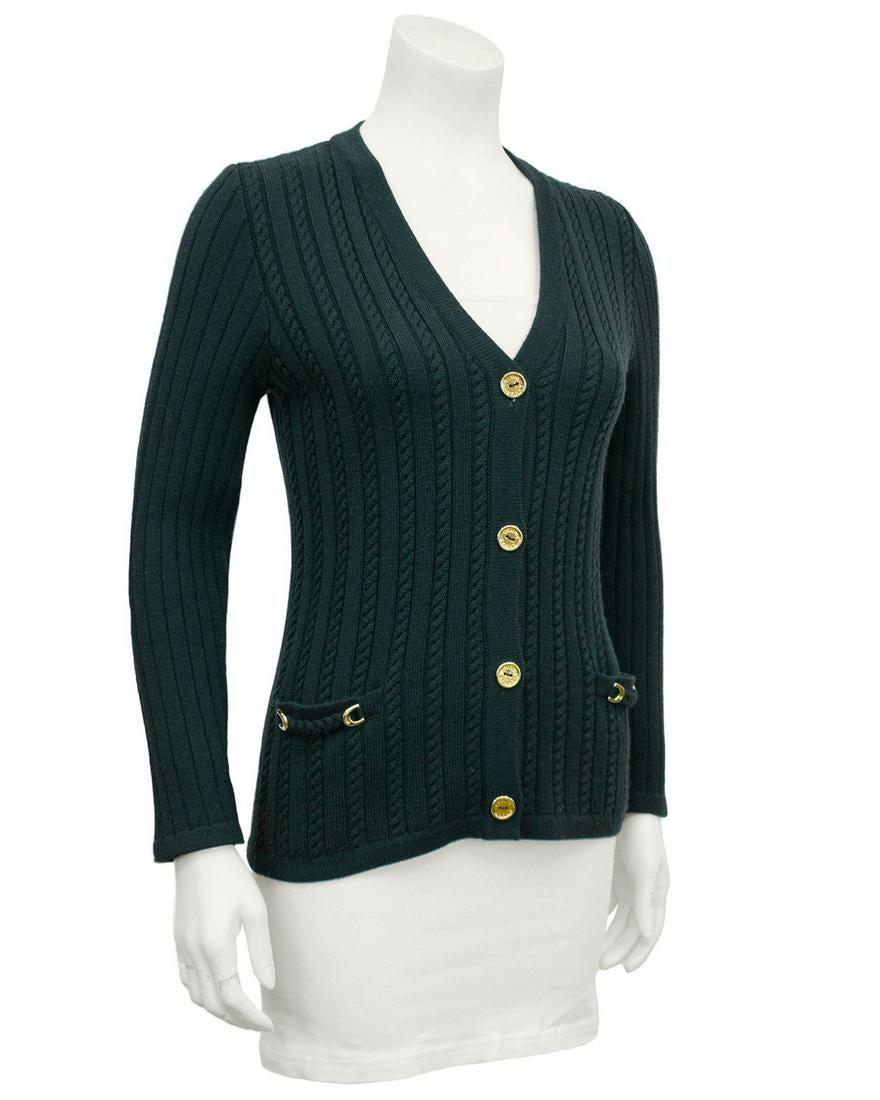 Celine Green cable knit cardigan: Hunter Green wool cable knit cardigan with gold Celine logo gold buttons and gold chain details at flat pockets. In excellent vintage condition, marked FR 38. Fits like a US 2-4. Reserve: $140.00 Ship