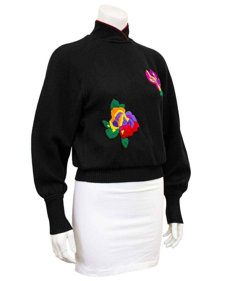 Ungaro Black wool knit sweater with oversewn florals: 1980s Ungaro knit mandarin collar sweater. Black with red trim at the neck and bright multicolour embroidered flowers. Ribbed neckline, cuffs and waist band. Three small black button closures at nape 