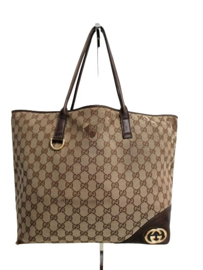 "Gucci" Tote bag in beige monogram canvas and leather: Description: (3026). Â“GucciÂ” tote bag in beige monogram canvas. Brown leather inserts and steel-colored metal applications, which represent the logo. Inner lining with red and green and white 