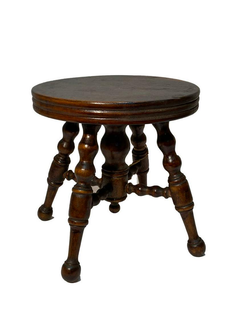 Piano Stool Salesman’s Sample: Title: Piano Stool Salesman’s Sample Dimensions: 7 ½” tall Provenance/Additional Info: A salesman/s sample walnut piano stool with turned legs. The surface is finished with original varnish and i