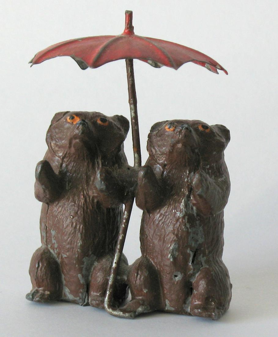Two bears under an umbrella.: Title: Two bears under an umbrella. Description: Two whimsical cast metal bears huddled under an umbrella, probably made by Spelter. All original paint. Dimension: 3 1/2” high Circa: 1920's Shipping