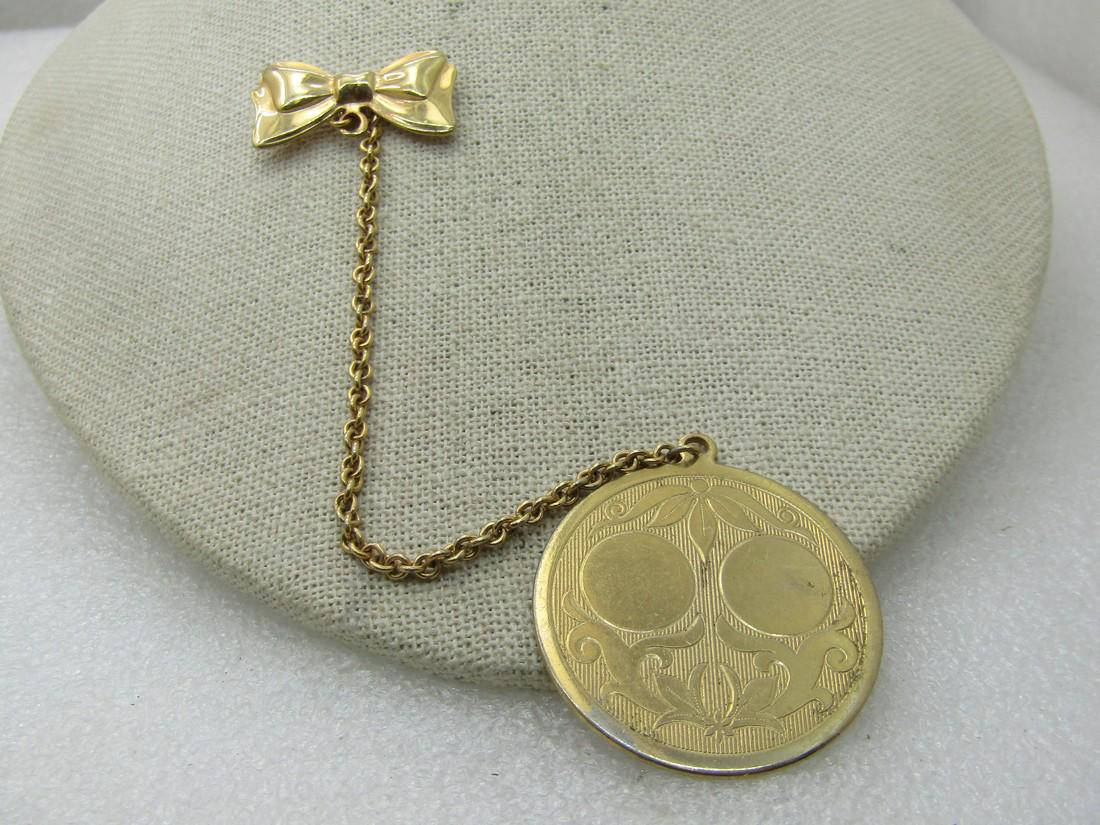 Vintage Bow and Round Engravable Pendant on Chain,: Vintage Bow and Round Engravable Pendant on Chain, Pre-mid-Century, Gold tone. Pendant is 1.5" with scrolled leaves that are smooth and shiny and two circles that can be engraved - same on both sides.