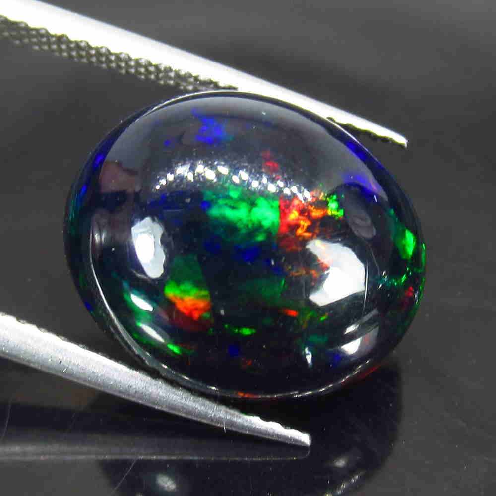 4.98 Ctw Natural Ethiopian Black Fire Opal Oval Cab: Title: 4.98 Ctw Natural Ethiopian Black Fire Opal Oval Cab Stone Clarity: Translucent Gemstones: Black Opal Carat Weights: 4.98 Size/Dimensions: 15.00 x 12.50 x 7.00 mm Additional Information: Excelle