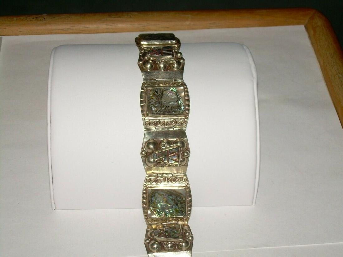 Vtg. Mexico Carved Abalone Mask Bracelet, Tiled 7",: Lovely vintage Mexican sterling silver carved Abalone hinged link bracelet - 6 tiles - 3 are rectangular tile links with bezel set abalone 1" x 7/8" and 3 are masks. They have carved designs to put th
