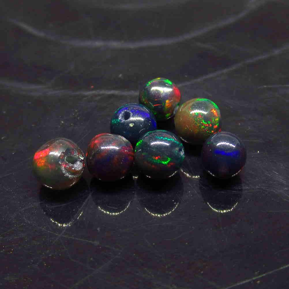 3.17 Ctw Natural 7 Drilled BlackFire Opal Ball Beads: No Reserve! Title: 3.17 Ctw Natural 7 Drilled BlackFire Opal Ball Beads Stone Clarity: Transparent Gemstone: Black Opal Beads Carat Weight: 3.17 Size/Dimensions: 4.30 to 5.10 mm / 7 PC's Additional In