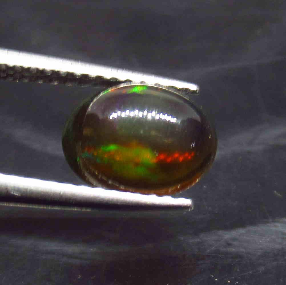 1.05 Ctw Natural Ethiopian Black Fire Opal Oval Cab: No Reserve! Title: 1.05 Ctw Natural Ethiopian Black Fire Opal Oval Cab Stone Clarity: Translucent Gemstone: Black Opal Carat Weight: 1.05 Size/Dimensions: 9.00 x 7.00 x 3.50 mm Additional Information: