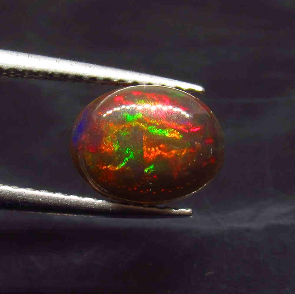 1.16 Ctw Natural Ethiopian Black Fire Opal Oval Cab: No Reserve! Title: 1.16 Ctw Natural Ethiopian Black Fire Opal Oval Cab Stone Clarity: Translucent Gemstone: Black Opal Carat Weight: 1.16 Size/Dimensions: 9.00 x 7.00 x 3.50 mm Additional Information: