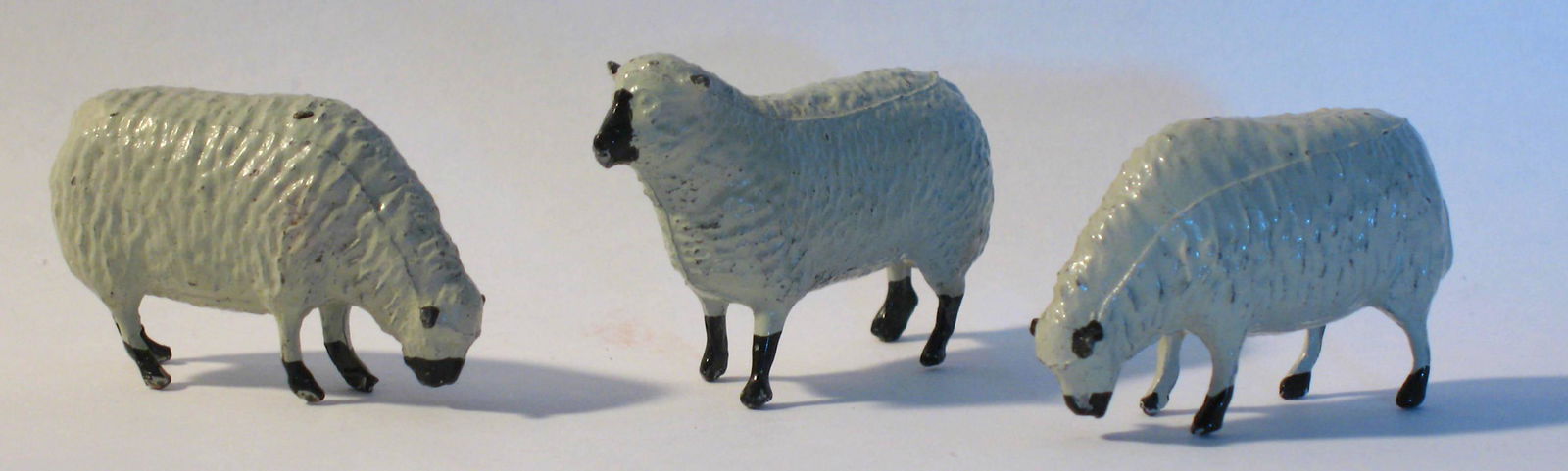 Three early cast metal sheep. (1 of 2)