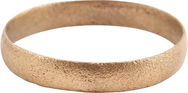 ANCIENT VIKING WEDDING RING SIZE 6 ¼: Late 9th-early 11th century AD. Gilt bronze, size 6 1/4. Medium band 2.9mm, with a rounded face. Surface textured and possibly decorated originally. Professionally refurbished with the 24karat gold ov