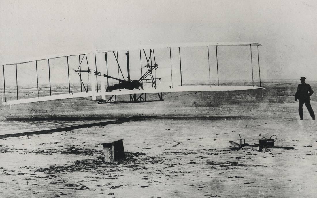 JOHN DANIELS - Orville Wright's First Flight, Kitty: Artist: JOHN DANIELS Title: Orville Wright's First Flight, Kitty Hawk, N. Carolina. Medium: Photo Litho, 1999, Hong Kong Dimensions: 8.65x5.4" Description: Heat Wax Mounted on 8.5x11" Conservation Boa