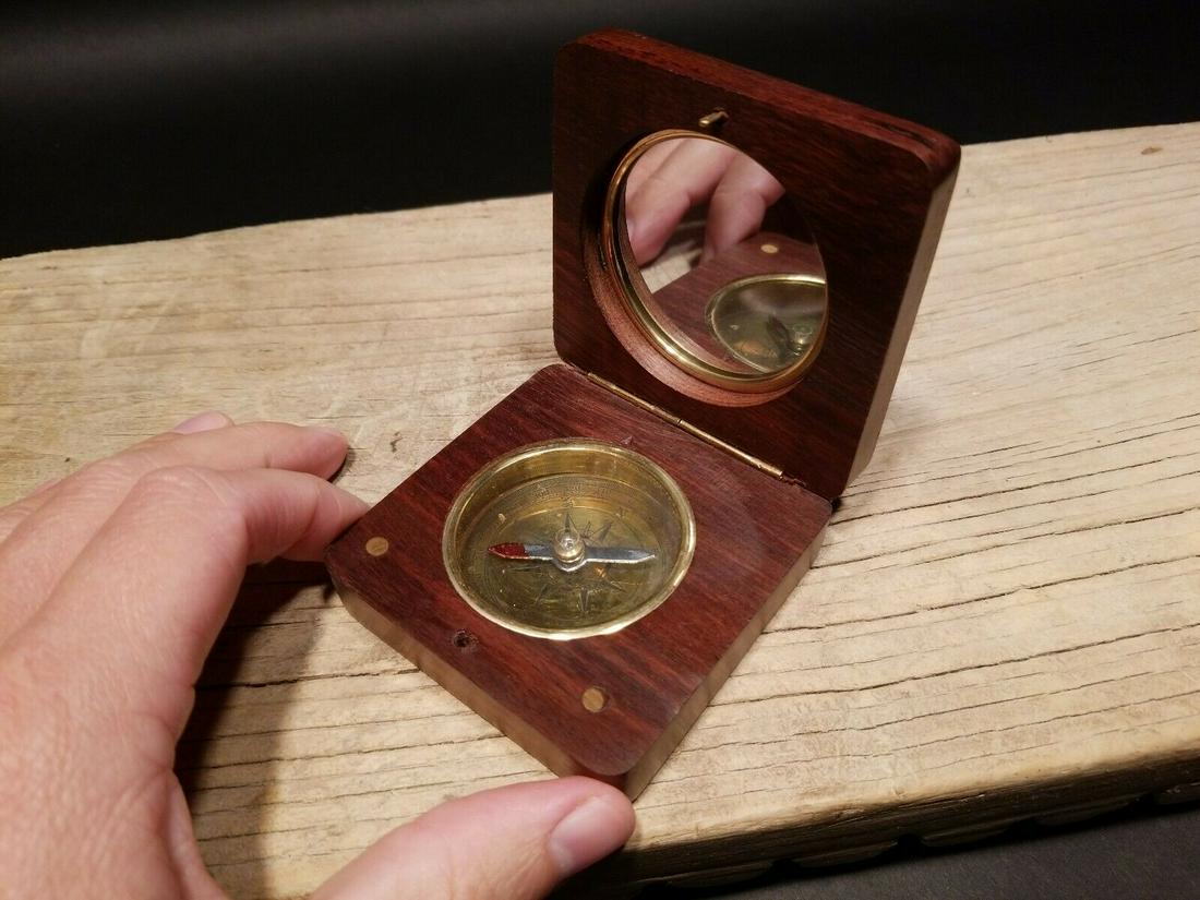 Wood and Brass Anchor Compass: 2 7/8" x 2 7/8" x 1" Such a neat reproduction antique compass. This is a hardwood and brass compass with a brass inlay anchor on the lid. The inside has a brass and glass compass with a signal mirror 
