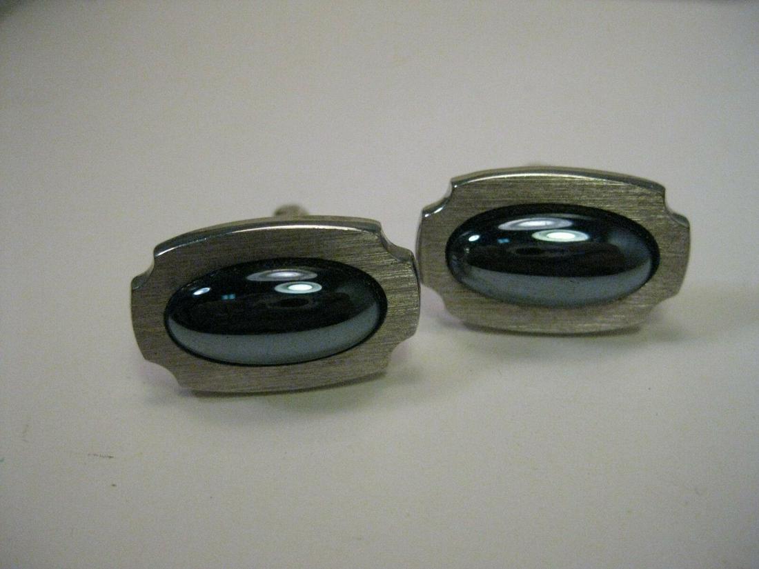 Vintage Silver Tone Hematite Cuff Links, signed Foster: Vintage Silver Tone Hematite Cuff Links, appx. 1960-1970. Signed Foster and pat. pending. They are nearly 1" wide and are 2/3 tall with a brushed silvertone finish and the center is a domed hematite (