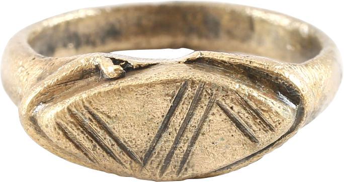MEDIEVAL EUROPEAN RING SIZE 11TH-13TH CENTURY, SIZE 4 ¾: 11th-13th century. Size 4 ¾ with rounded face tapered band flaring to the shoulders. Stepped bezel as sometimes found on Viking rings of the period. Pointed oval top cut with three bands of thr