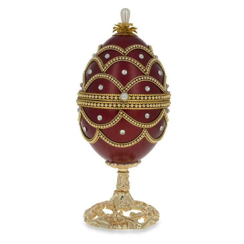 Musical Decorative Faberge Egg crystals Jewelry Box: DESCRIPTION: The egg is made from a real eggshell with translucent burgundy enamel color, adorned with Austrian crystals and golden trim. The top opens on a hinge and has a magnetic closure to keep th