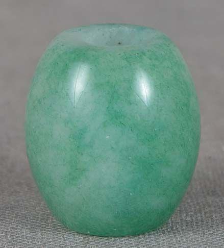 19c jadeite OJIME netsuke slide: Late 19th century jadeite ojime (slide bead for tightening the cord going from netsuke to inro) in simple barrel shape. Beautiful stone with play of green and white, large central hole, pleasant patin