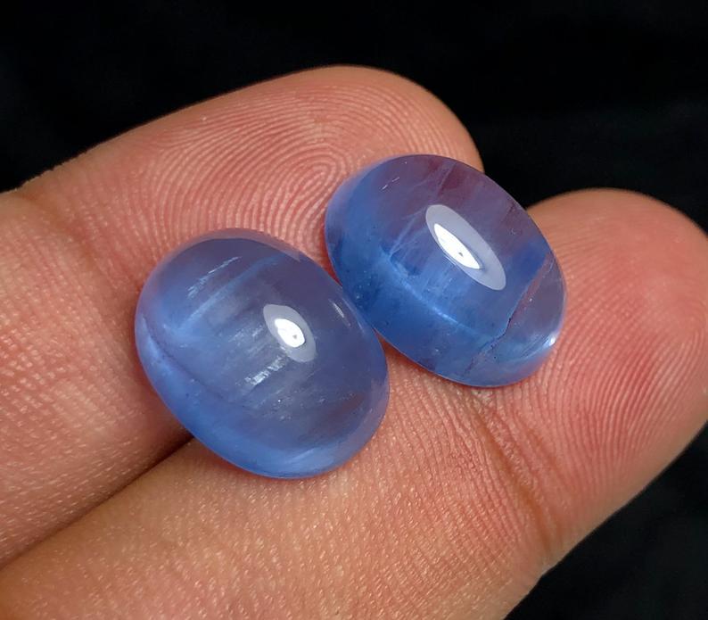 Cat's Eye Aquamarine Cabochon Gemstones Pair Navy Blue: Materials Aquamarine, beryl Dimensions Carat weight: 18.35 Description Cat's Eye Aquamarine Cabochon Gemstones Pair Navy Blue Color Weight - 18.35 Carats Dimensions - 15*11*7.