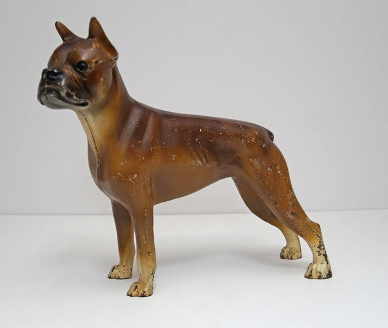 Antique Boxer Dog Cast Iron Hubley Doorstop: Title: Antique Boxer Dog Cast Iron Hubley Doorstop Date: Circa 1930s Dimension: 8 5/8” tall x 9” wide Provenance/Additional Info: Striking portrayal of a full-figure Boxer. Painted in a slight bri