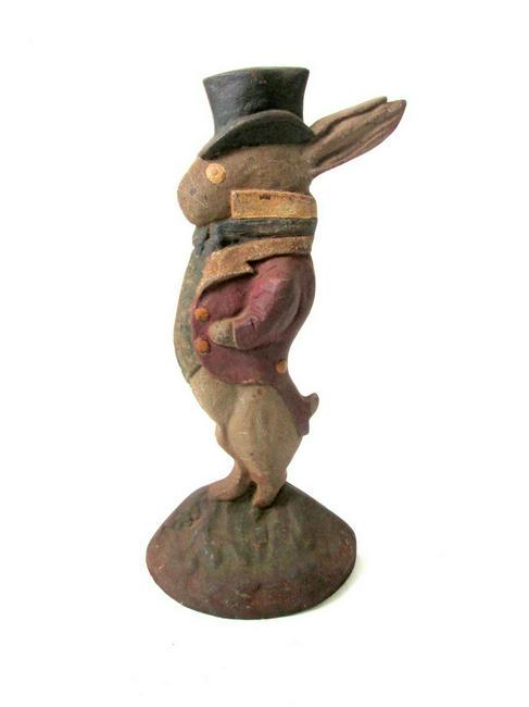 Rabbit With Top Hat Doorstop: Title: Rabbit With Top Hat Doorstop Date: C 1920 Material: Cast Iron Dimension: 10”H X 5”W X 2”D Provenance/Additional Info: Great whimsical form, the rabbit dressed in tuxedo with top hat, dry 