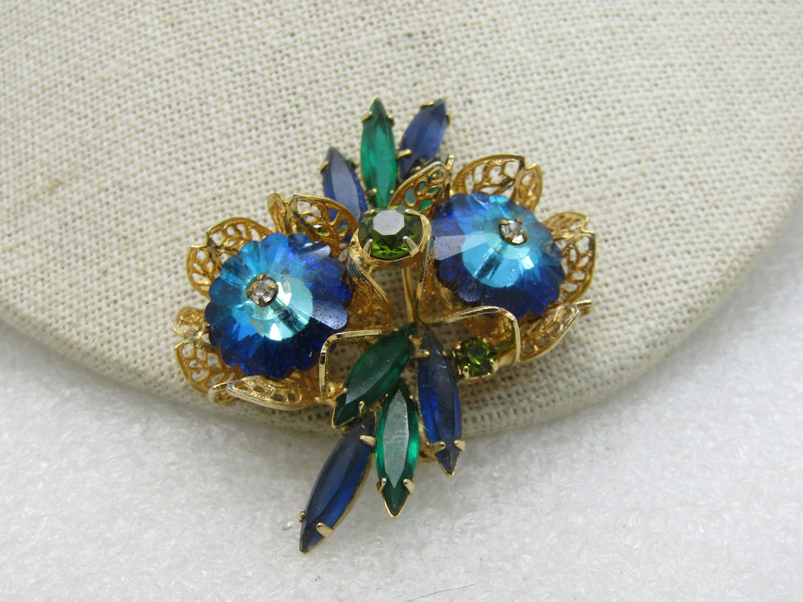 Vintage Blue Rivoli & Rhinestone Brooch, Filigree,: Vintage Blue Rivoli Rhinestone Floral Brooch with green and blue navettes - the rivoli stones are cupped in a filigree setting - Juliana style. 2.25" by 1.5". 1960's piece that is very well made, very