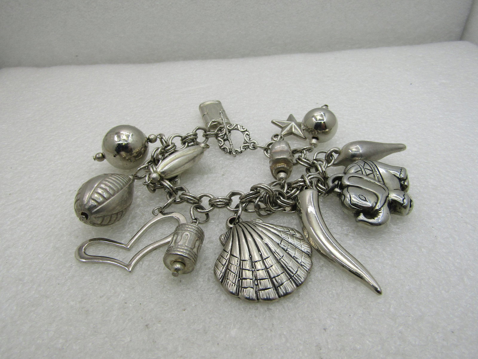 Vintage Mixed Genre Charm Bracelet, 7.5", Chunky,: Vintage Mixed Genre Charm Bracelet, 7.5", Chunky, Toggle Clasp. Silver tone with a mix of ethnic and cultural style charms from elephants to Bali beads, seashell, horns, stars, hearts and more. The ch