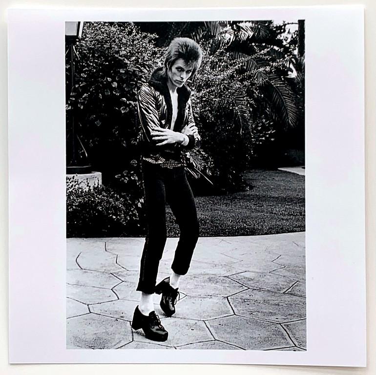 Mick Rock: Beverly Hills Hotel- David Bowie-1972: Title: Mick Rock Artist: Beverly Hills Hotel- David Bowie-1972 Medium: B/w photograph Dimension: 6" x 6" Additional Information: B/w photograph signed in ink verso Reserve: $200.00 Shipping: Domestic: