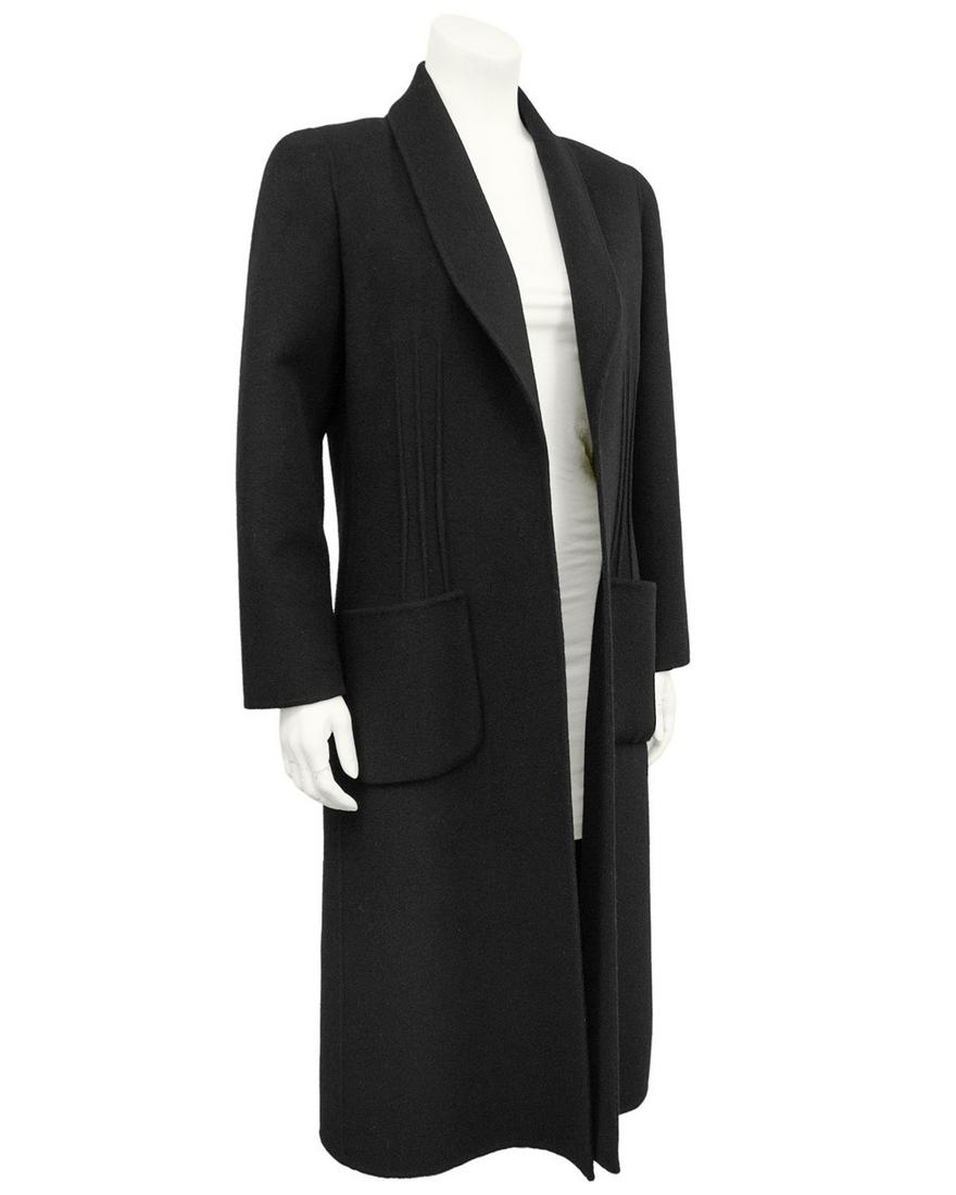 Andre Laug Black Wool Jacket: 1980s Andre Laug black felted wool long coat. Long sleeves with shawl lapel and patch pockets. Designed to be worn open. Ribbed detail at seams. Unlined. Works like an easy light layer over anything f