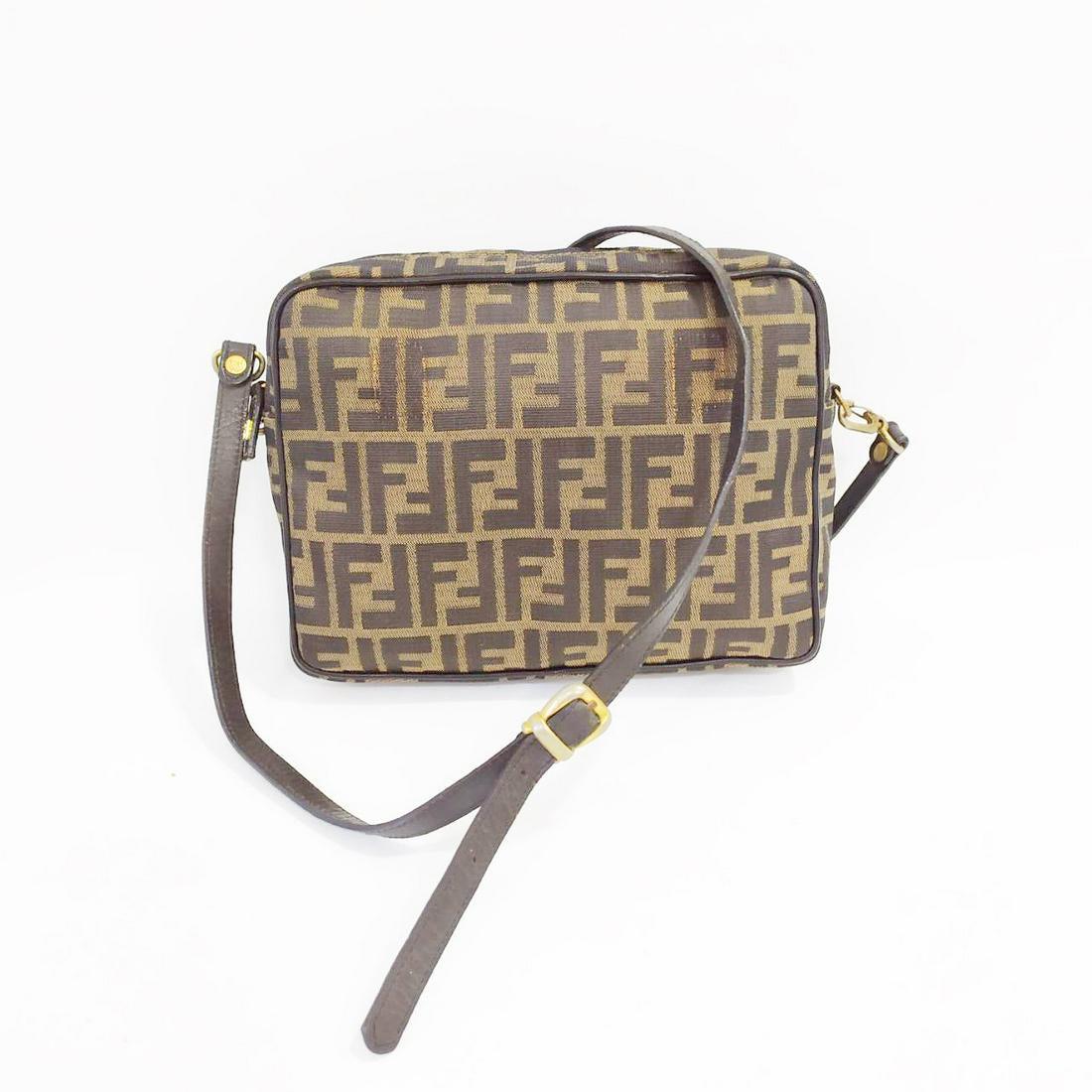 Fendi Zucca Shoulder Bag: Title: Fendi Zucca Shoulder Bag Brand: Fendi Date: N/A Materials: Canvas Measurement: Length: 10" Height: 7.5" Width: 2.5" strap drop 21" Additional Information: Fendi Zucca Crossbody bag. This was or