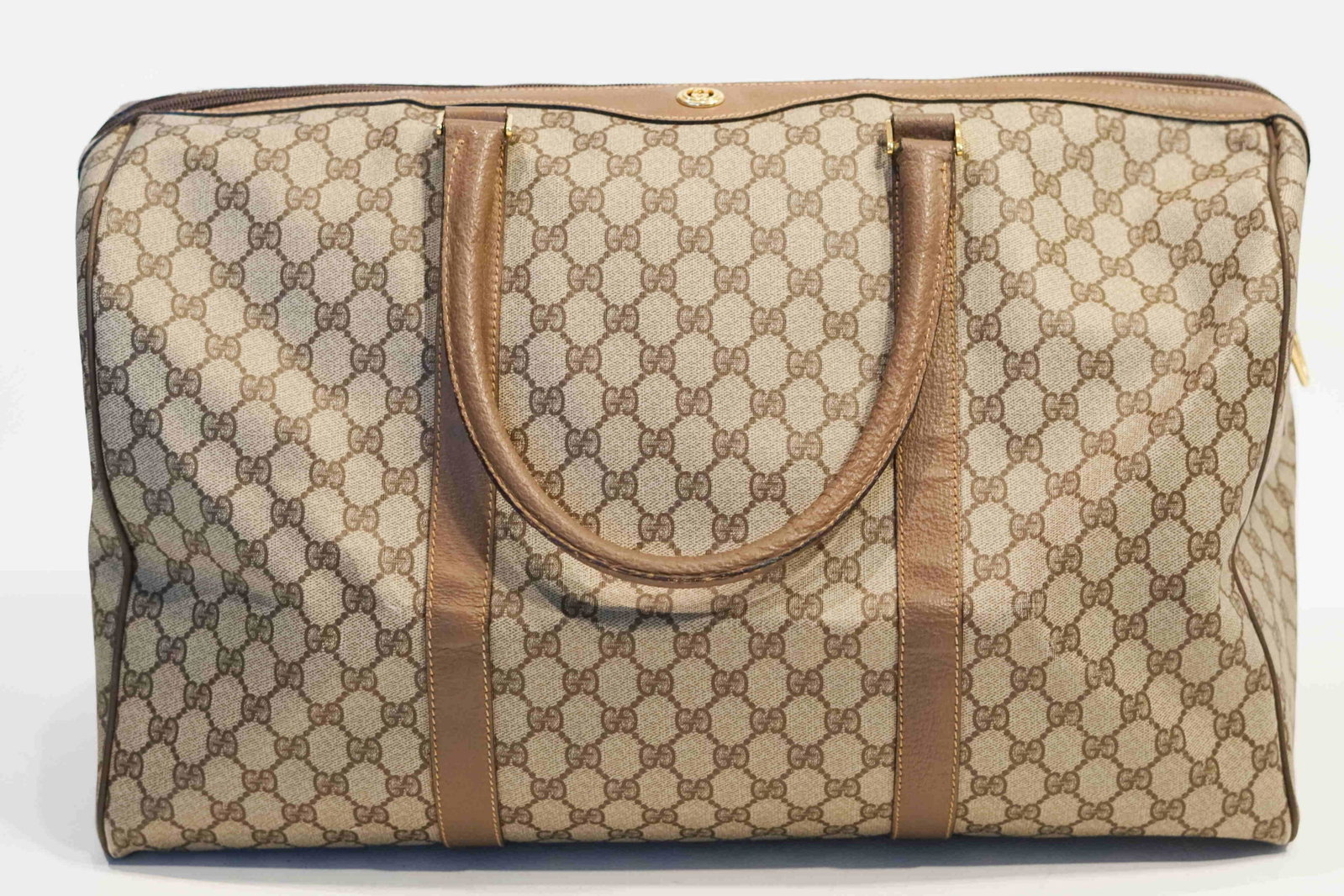 Gucci Monogram Travel Bag: Title: Gucci Monogram Travel Bag Brand: Gucci Date: 1980s Materials: PVC/Leather Measurement: L 20 H 11.5 W 9.5 Additional Information: Gucci Monogram Travel Bag is a large PVC travel bag. Some slight