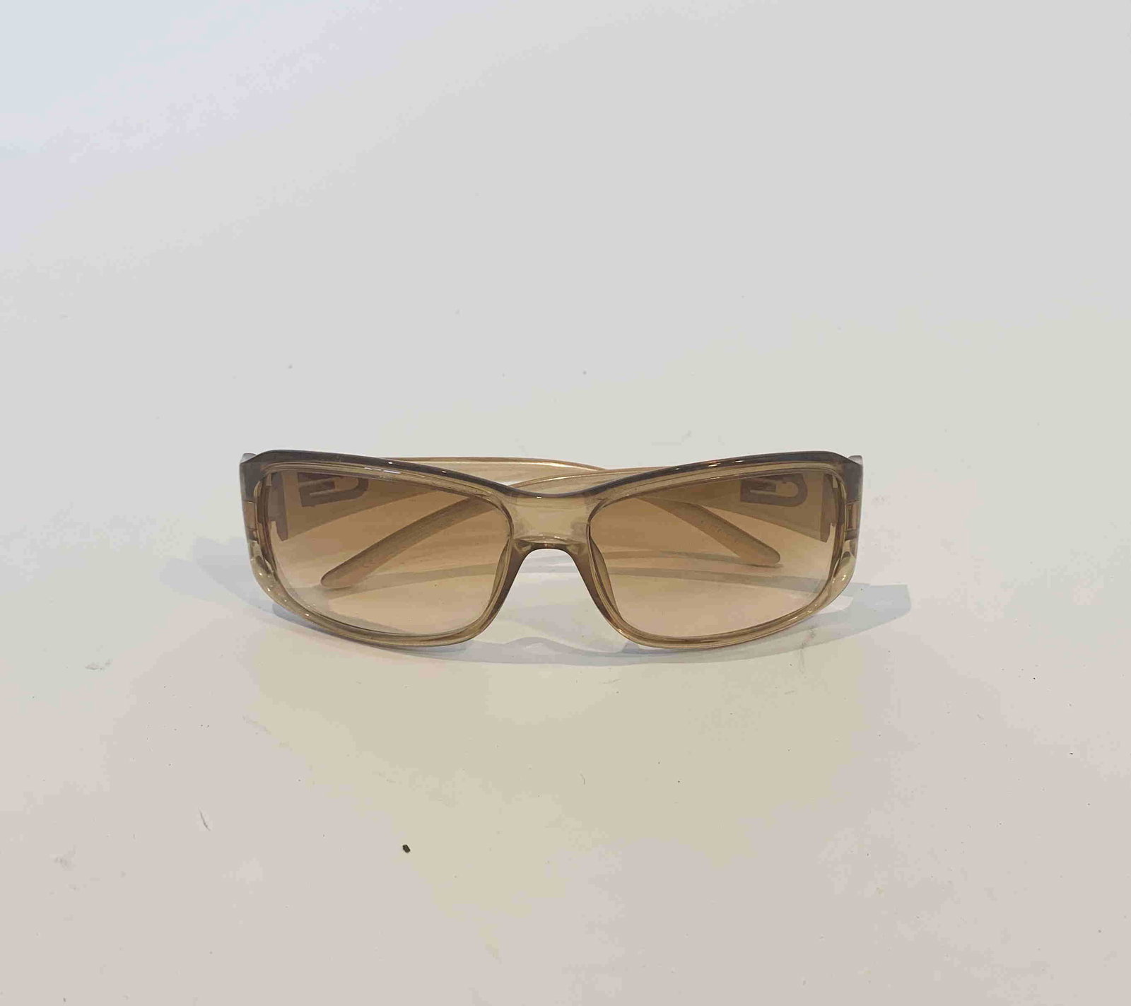 Gucci Vintage Sunglasses: Title: Gucci Vintage Sunglasses Brand: Gucci Date: N/A Materials: N/A Measurement: N/A Additional Information: Gucci Vintage Sunglasses have a beige frame and brown lenses. The exterior has a "G" Logo