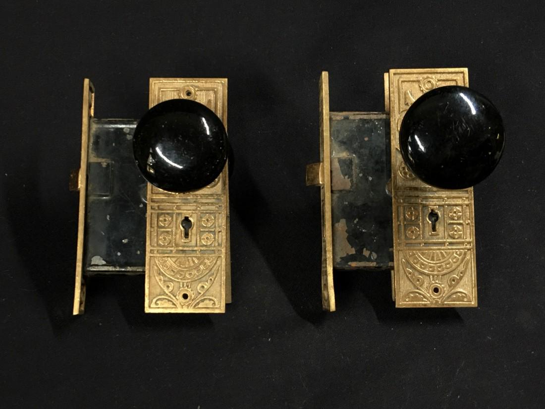 2 ornate bronze Victorian door hardware sets back: Title: 2 ornate bronze Victorian door hardware sets back plates, knobs, and lock-sets Date/Period: 1880-1900 Materials: Cast bronze lock sets with black ceramic knobs Dimensions: H.6 x W.2 inches lock