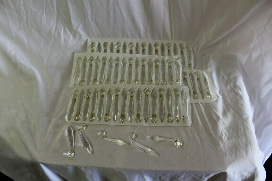 Crystal Chandelier prisms , 4" long ,brass hooks , new: Chandelier Crystals . Still in the box,s left over from a big Chandelier project . Could be used on wall sconces as well ,or lamps . There are 73 left . Priced to sell . Reserve: $75.00 Shipping: Dome