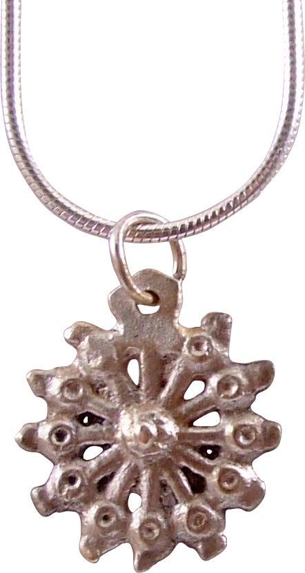 ROMAN WHEEL OF FORTUNE NECKLACE PENDANT C.100-450 AD: Just over 5/8” diameter. Wheel form with a scalloped edge. Raised central circle with twelve spokes. The concept of the Rota Fortunae, the Wheel of Fortune, dates back millennia with the Roman godde