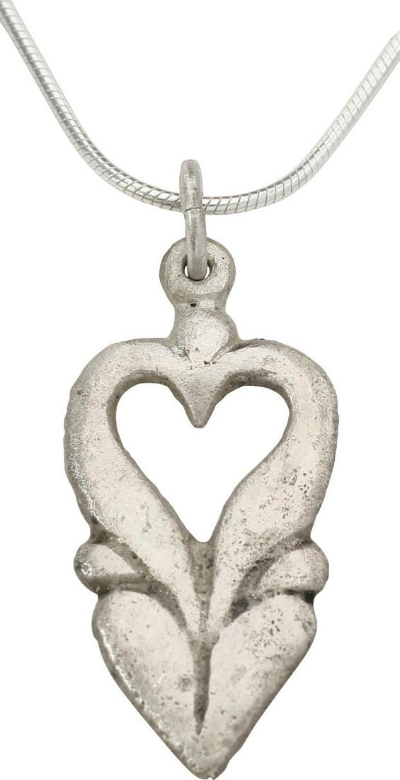 EXTRAORDINARY VIKING HEART PENDANT NECKLACE 850-1050 AD: Very fine example in its fully evolved form. 1.13” height. Of overall heart form with cusped top, and actually comprised of two individual hearts The upper as a broad bordered pierced heart above a 