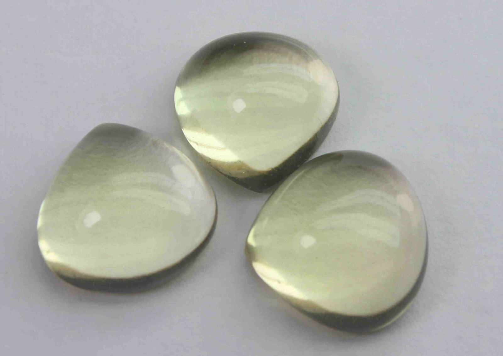 12.69 Ct Natural Lemon Quartz Lot: No Reserve! Title: 12.69 Ct Natural Lemon Quartz Lot Additional Information: Gemstone : Natural Lemon QuartzWeight : 12.69 CtShape : Pear CabochonColour : Greenish Yellow Dimensions : 10.7x11x5.7 mm ,