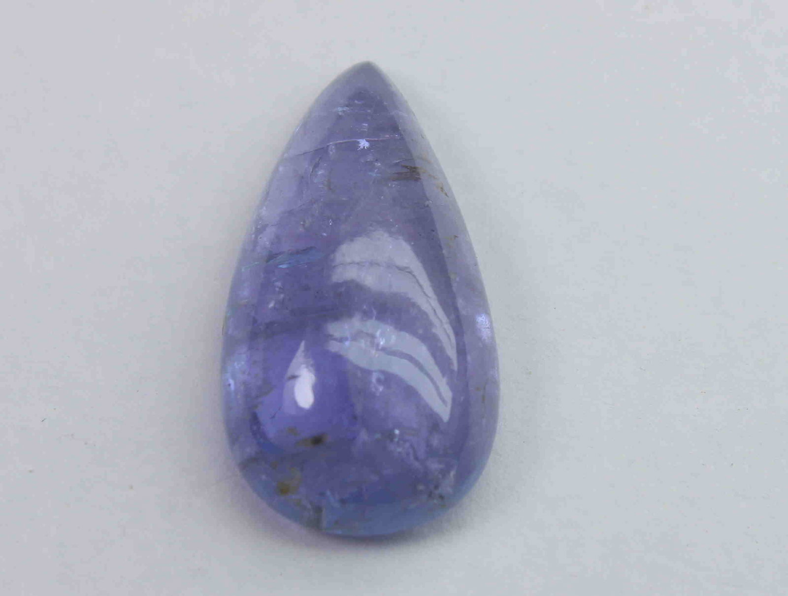 10.13 Ct Natural Tanzanite: No Reserve! Title: 10.13 Ct Natural Tanzanite Additional Information: Gemstone : Natural Tanzanite Shape : Pear CabochonMeasurements : 20.1x10.5x5.9 mmWeight : 10.13 CaratsColor : Bluish Violet Transp