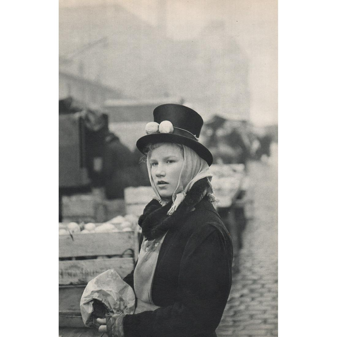 HENRI CARTIER-BRESSON - Girl Selling Lemons at the Fish: Artist: HENRI CARTIER-BRESSON Print Title: Girl Selling Lemons at the Fish Market, Hamburg Medium: Sheet-fed Gravure Printing Date: 1950's Printed in France Image Size approx: 13.5 x 9 inches Henri Ca