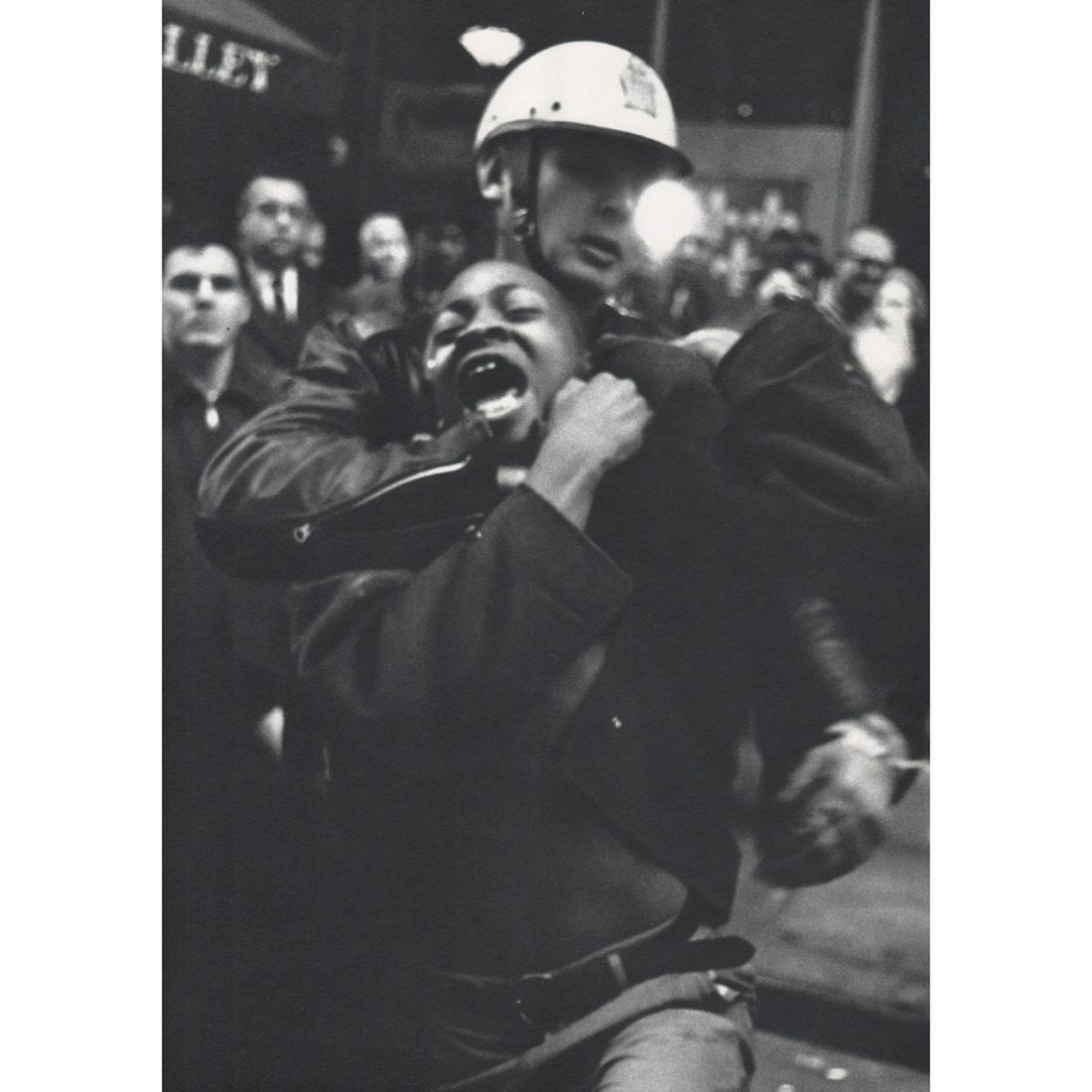 DANNY LYON - Arrest of Taylor Washington: Artist: DANNY LYON Print Title: Arrest of Taylor Washington, Lebs Restaurant, Atlanta, 1960's Medium: Sheet-fed Gravure Printing Date: 1960's Printed in Italy Image Size approx: 11.5 x 8 inches Danny