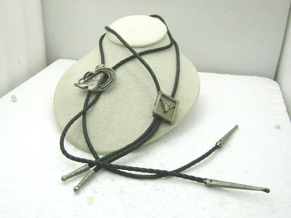 Vintage Pair of Southwestern Bolo Ties,, Steer & Lasso: Vintage Pair of Southwestern Bolo Ties, Steer & Lasso & Boot, 1970's, black braided leather ties with silver tone tips, 32" and 36", Very good condition. Not signed by the maker. (INV.W31420.1X1 SS167