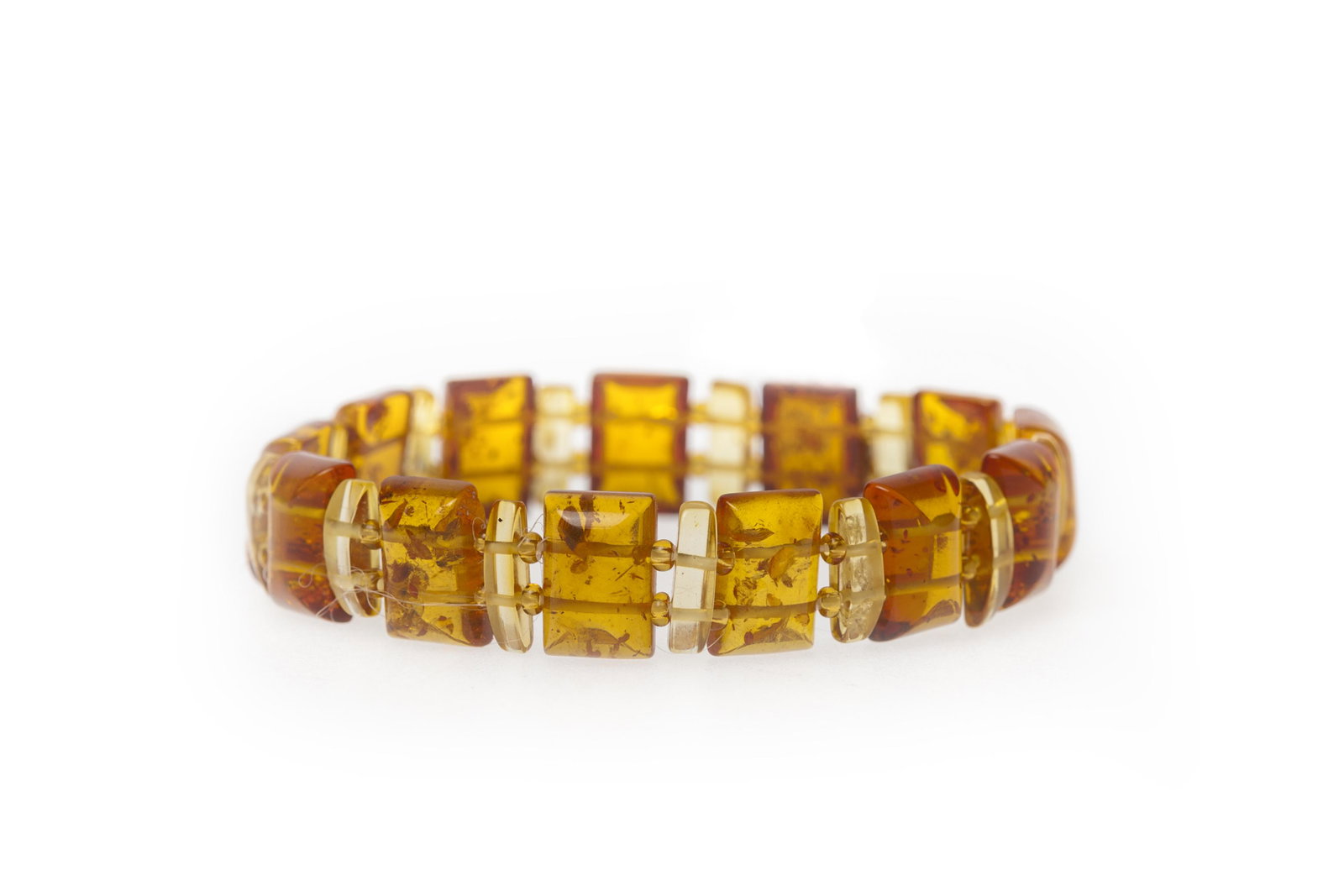 Natural Baltic Amber Bracelet: Title: Natural Baltic Amber Bracelet Materials: Natural Baltic Amber Weight in grams: 6.34 Additional Information: Natural Baltic Amber Bracelet. Calibrated finish. Cabushon shaped. Lemon and Cognac c
