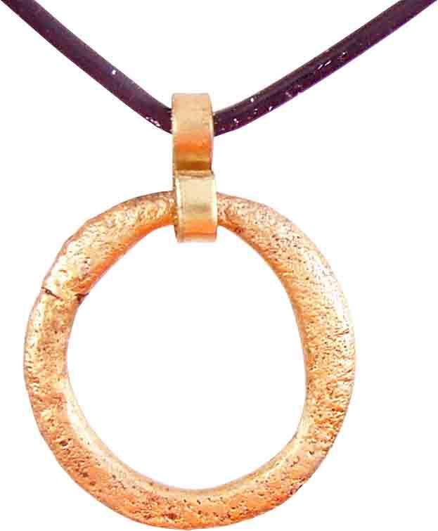 VIKING PROTECTIVE BROOCH PENDANT 10th CENTURY: Circular bronze, just under 1” diameter. Rounded face angled to the flat-sided center hole, flatback. Suspended from the pin notch. The surface with light texture from burial. Professionally conserv