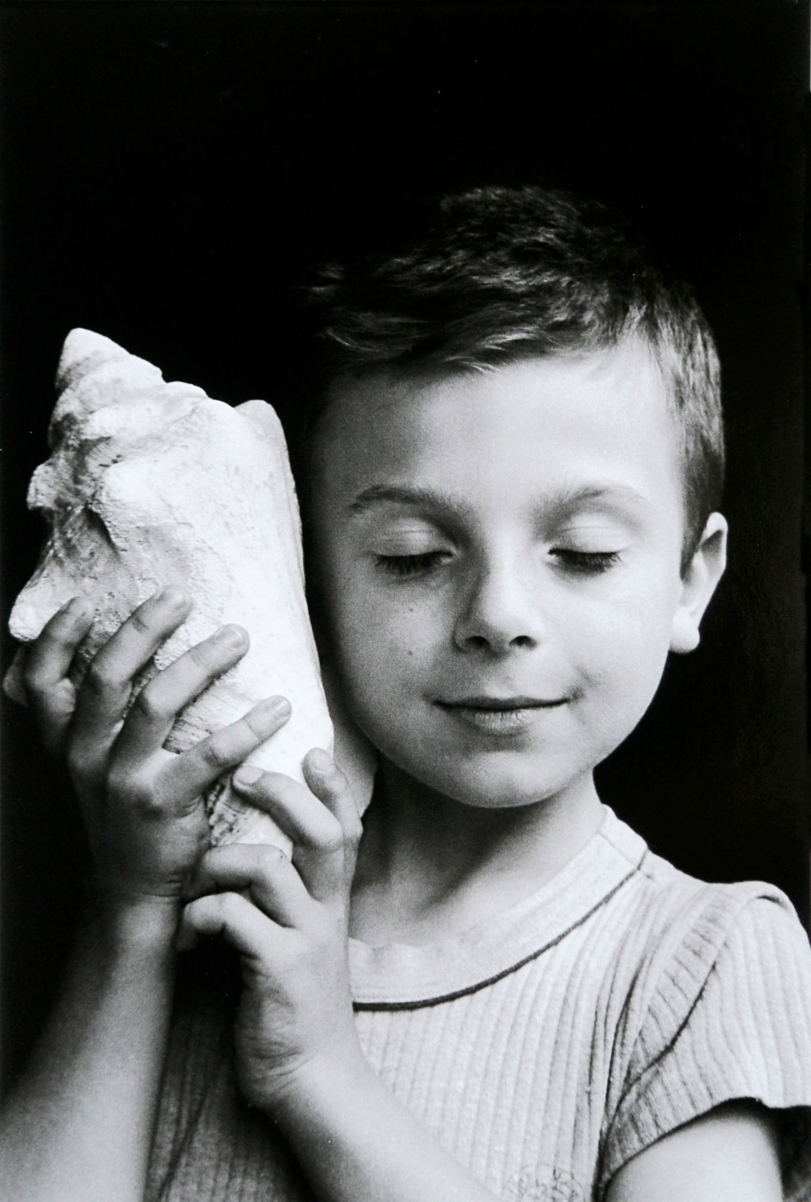 Remy listening the sea. Paris, 1995: Artist: Edouard Boubat Title: Remy listening the sea. Paris, 1995 Date Printed: 2008 Medium: Photo Litho with Copyright Edouard Boubat/RAPHO/EYEDEA Printer Location: Italy Dimensions: 14.7x22 cm - 5.7