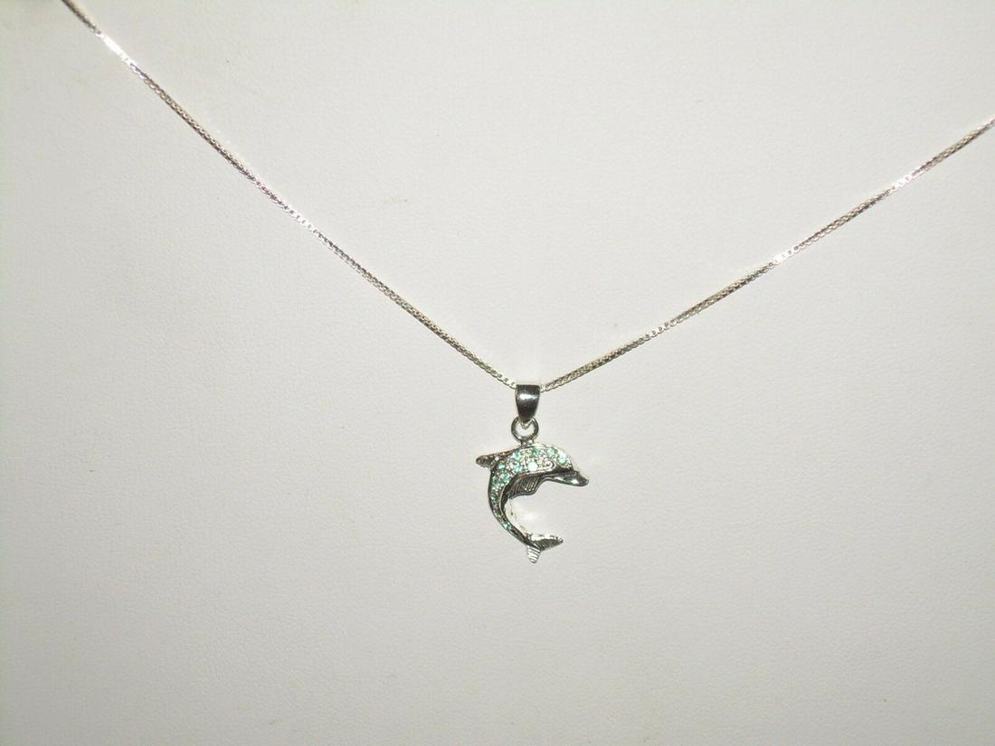 Sterling Dolphin Necklace With Aquamarine Rhinestones -: Vintage sterling silver necklace is 18" long. Necklace comes with a dolphin who has aquamarine rhinestones throughout his body. The dolphin is 1" long. It has a spring clasp which is marked 925. The n