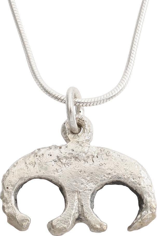 FINE VIKING LUNAR PENDANT NECKLACE C.900-1000 AD: Silvered bronze, formed like a crescent embracing two addorsed crescents probably representing Sol the Sun and Mani the Moon. As expert navigators, the constellations signified mystery and power to Vi