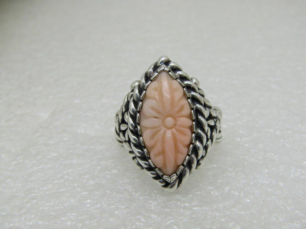 Sterling Carolyn Pollack Relios Floral Ring, carved: Sterling Carolyn Pollack Relios Floral Ring, carved pink coral stone set in a rope accent pointed tiered frame with a crossover rope accent band. 10.45 grams and a size 8.25. The stone is appx. 18mm b