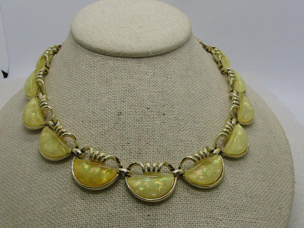Vintage Coro Yellow Confetti Necklace - 16" long and: Vintage Coro Yellow Confetti Necklace - 16" long and 3/4" drop with a curled top to the links and a yellow confetti half-moon stone in each link. 11 total links. Gold Tone. 1960's. Good to very good c