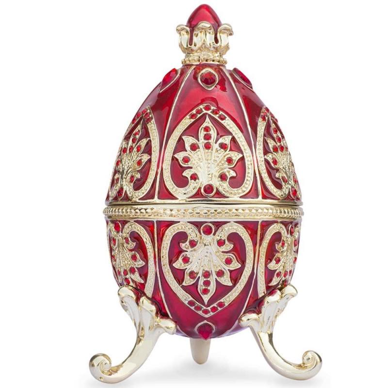 Decorative red-hued Royal inspired Russian Faberge egg: DESCRIPTION: You'll love the elegance of this red-hued Royal inspired Russian egg. A display stand attached to this beauty. Fashioned from fine pewter. Then it is hand enameled by our skilled artisans