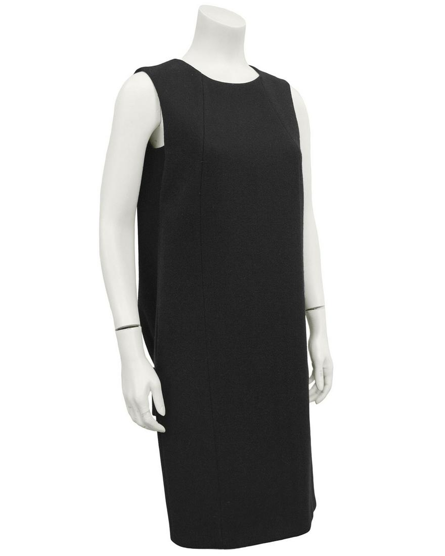 Prada Black Wool Shift Dress: Title: Prada Black Wool Shift Dress Additional Information: Stunning 1990s Prada black wool dress. Simple sleeveless from the front with two side seams. Back features a large inverted box pleat down t