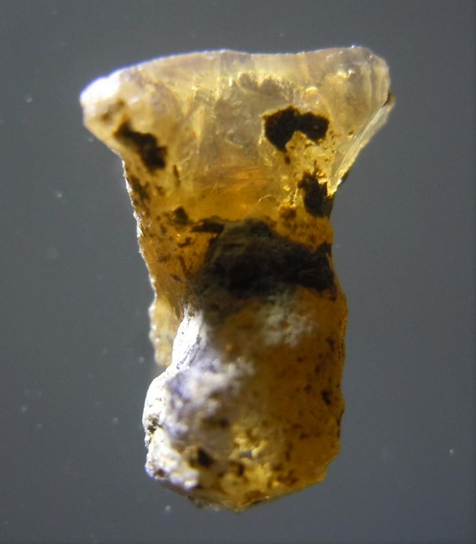 2.05 CT PRECIOUS OPAL - UNTREATED GEMSTONE: Title: 2.05 CT PRECIOUS OPAL - UNTREATED GEMSTONE Origin: South Welo. Amhara Prov. Ethiopia Size: 1.25x0.9x0.55 cm / 0.41 gram transparent precious opal with some play-of-color Reserve: $3.00 Shipping