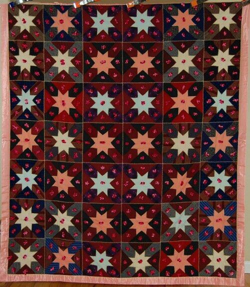 Graphic 20's "New Star" Quilt: This wool "new star" tied quilt is hand pieced, with hand embroidered accents and a subtle secondary design where the pastel colored stars "float" above the background. It measures 68" X 80" and is in